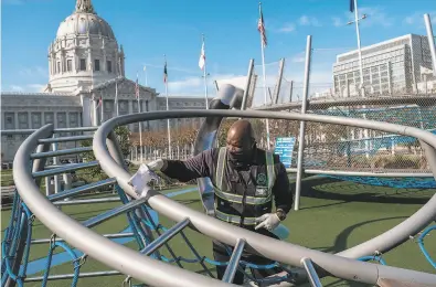  ?? Nick Otto / Special to The Chronicle ?? Perry Lennon of Urban Alchemy cleans the Civic Center playground in San Francisco to prepare for reopening.