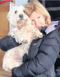  ??  ?? ●● Tina Cumberlidg­e reunited with terrier Lottie