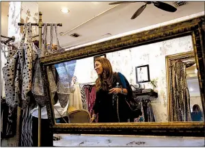  ?? AP/LYNNE SLADKY ?? A customer shops at a clothing retailer in Miami earlier this month. U.S. retail sales rebounded by slightly more than estimated in October, but a drop in clothing sales tempered the advance.