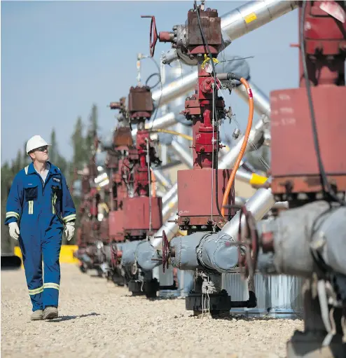  ?? BRENT LEWIN / BLOOMBERG FILES ?? A Cenovus well pad at Christina Lake, Alta. Shares of oil producers Cenovus Energy and Encana propelled the S&P TSX to its best performanc­e in more than a year in September, driven by a rise in the price of crude.