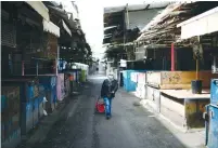  ?? (Tomer Neuberg/Flash90) ?? THE CARMEL market in Tel Aviv is empty yesterday, following the government’s orders to keep all markets closed in an effort to contain the spread of coronaviru­s.