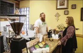  ?? REANN HUBER / REANN.HUBER@AJC.COM ?? Missy Owen, executive director of the Davis Direction Foundation, talks with Justin Jackson in late June in the cafe at The Zone in Marietta. The Zone is operated by the foundation to support people in recovery.