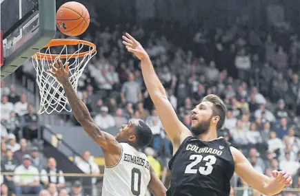  ?? Bethany Baker, The Coloradoan ?? CSU guard Hyron Edwards takes a shot against the defense of CU forward Lucas Siewert on Friday night at Moby Arena during the Buffs’ 56-48 victory.