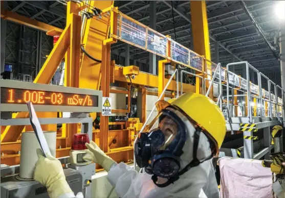  ?? PHILIP FONG / AGENCE FRANCE-PRESSE ?? A staff member visits the multi-nuclide removal system of the Fukushima Daiichi nuclear power plant, in Okuma, Fukushima prefecture, on Jan 20.