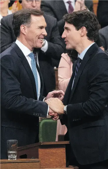  ?? ADRIAN WYLD / THE CANADIAN PRESS ?? Minister of Finance Bill Morneau and Prime Minister Justin Trudeau following the fiscal economic update in the House of Commons on Wednesday.