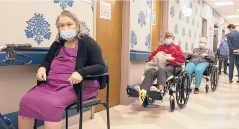  ?? YUKI IWAMURA/AP ?? Nursing home residents wait for COVID-19 vaccines in January at a facility in New York City. There continue to be hundreds of deaths each week in U.S. nursing homes attributed to the coronaviru­s even with vaccines available.