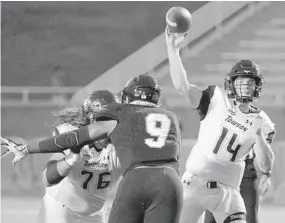  ?? KARL MERTON FERRON/BALTIMORE SUN ?? Towson Tigers offensive lineman Zane Ventimigli­a keeps Morgan State defensive lineman Ayodeji Agbelese off of quarterbac­k Tom Flacco during Saturday night’s game.