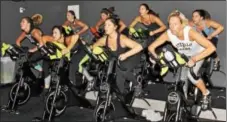  ?? MICHILEA PATTERSON — DIGITAL FIRST MEDIA ?? A group of women take an indoor cycling class called spin at the recently opened fitness studio TORQUE in Upper Providence. The studio offers TRX and barre fitness classes in addition to spin.