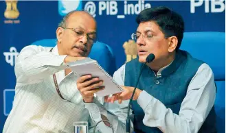  ?? — PRITAM BANDYOPADH­YAY ?? Union minister of state (IC) for power, coal, new & renewable energy & mines Piyush Goyal talks to ministry of power secretary P.K. Pujari (left) while addressing a press conference in New Delhi on Monday