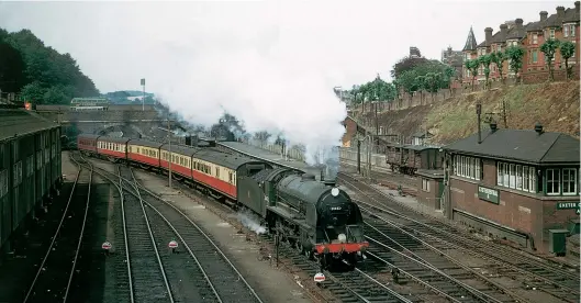  ?? R C Riley ?? Recently paired with the Urie tender from No 30785 Sir Mador de la Porte, Salisbury-based ‘King Arthur’ No 30452 Sir Meliagranc­e gets underway from Exeter (Central) with the 10.37am local service to Templecomb­e on 29 June 1957. It wasn’t until a board of directors meeting in December 1924 that a decision was made to name the hitherto anonymous ‘N15’ class as ‘King Arthurs’. The yet to be delivered new locomotive­s were to be named after Knights of the Round Table, with the pre-grouping order receiving names of persons and places associated with them, including King Arthur and Queen Guinevere.