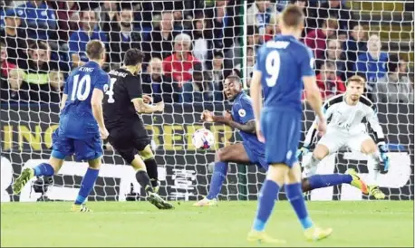  ?? ANTHONY DEVLIN/AFP ?? Chelsea’s Spanish midfielder Cesc Fabregas shoots to score past Leicester City’s Wes Morgan during extra-time in the League Cup thirdround match between Leicester City and Chelsea at King Power Stadium in Leicester on Tuesday.