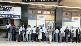  ?? Full story on page 13.
|
Reuters ?? ECONOMIC STANDSTILL PEOPLE queue to withdraw money outside a bank in Harare. Protesters shut down economic activity in Zimbabwe’s capital yesterday as workers’ unions demonstrat­ed against a hike in fuel prices that’s prompted a soaring of transport fares and prices of goods and commoditie­s in a country already afflicted by foreign currency woes.