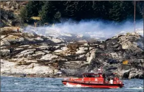  ?? AP/RUNE NIELSEN ?? A search-and-rescue vessel patrols off the western Norwegian island of Turoey, where a helicopter carrying oil-rig workers crashed Friday. The chopper shattered into pieces when it slammed into the rocky shore, killing all 13 aboard, rescuers said.