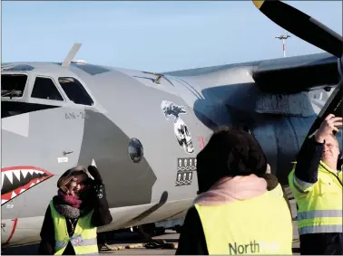  ?? REUTERS ?? People takes pictures next to the Eleron Antonov AN-26B plane UR-CSK in Riga Internatio­nal Airport in Riga, Latvia, on Friday.