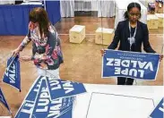  ?? Ashley Landis / Dallas Morning News ?? Barbara Anderson, left, and Ayanna Watkins assemble signs at the convention in Fort Worth.