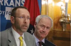  ?? (Arkansas Democrat-Gazette/ John Sykes Jr.) ?? Arkansas Health Secretary Nate Smith, left, along with Governor Asa Hutchinson talks about the effects of the covid-19 virus on the state at the governors conference room Tuesday afternoon, June 2, 2020.