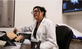  ?? ?? Gynaecolog­ist Rubena Moisiu performs a sonogram on a pregnant woman in Tirana.