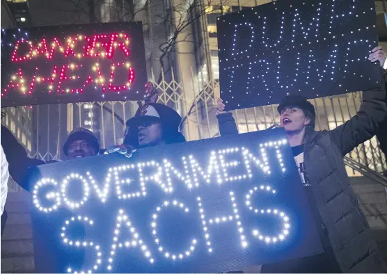  ?? DREW ANGERER/GETTY IMAGES ?? Activists rally against U.S. President Donald Trump’s reported plans to loosen Wall Street regulation­s and review the Dodd-Frank Act as they march toward Goldman Sachs headquarte­rs on Tuesday in New York. The global regulatory system is under pressure...