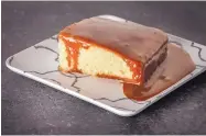  ?? GORAN KOSANOVIC/THE WASHINGTON POST ?? Poured Caramel Cakes start with a yellow sheet cake typically brought to Southern gatherings and flavorful enough to serve plain. The caramel is silky soft and sticky, and pourable without being too runny.