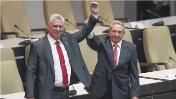  ??  ?? Cuba’s new president Miguel Diaz-Canel (left) and former president Raul Castro, raise their arms after Diaz-Canel was elected as the island nation’s new president, at the National Assembly in Havana, Cuba yesterday.