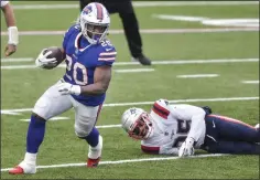 ?? ADRIAN KRAUS - THE ASSOCIATED PRESS ?? Buffalo Bills’ Zack Moss (20) rushes past New England Patriots’ Terrence Brooks (25) during the first half of an NFL football game Sunday, Nov. 1, 2020, in Orchard Park, N.Y.