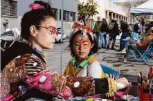  ?? ?? Sugar Yum Yum paints Ami’s face at the Treat Avenue Greenspace Event. The event aims to turn the block into a green space.