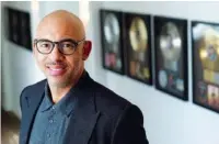  ?? AP PHOTO/CHRIS PIZZELLO ?? Harvey Mason jr., CEO of The Recording Academy, stands amongst commemorat­ive records he has worked on during his career, while at Harvey Mason Media music production studios on Oct. 11 in Burbank, Calif.