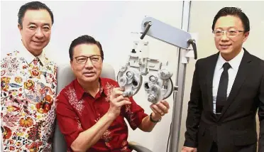  ??  ?? Expansion mode: Liow (centre) getting his eyes checked during the launch. With him are Tan (left) and consultant ophthalmol­ogist Dr Chang Khai Meng.