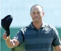  ?? — Reuters ?? Tiger Woods finishes out his round on the 18th green during first round play of the 2018 Masters at the Augusta National Golf Club in Augusta, Georgia, US.