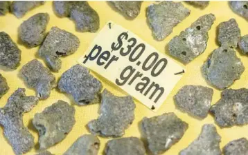  ?? ?? Trinitite, for sale at a rock shop in Bingham, N.M., formed when sand, liquefied by the 1945 atomic blast, fell back to Earth.
