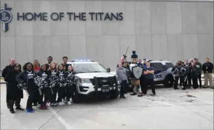  ?? ERIC BONZAR — THE MORNING JOURNAL ?? Lorain police arrived at Lorain High School to show their Titan pride. The department has added six new vehicles to their fleet, including two Ford Explorers designated for road patrol with a new color scheme. The department chose to forego its...