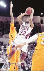  ?? Rogelio V. Solis/associated Press ?? Mississipp­i State guard Brian Bryant shoots over the attempted block by Tennessee guard Jordan Mcrae in the Bulldogs’ 62-58 victory.