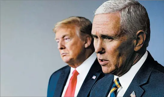  ?? MANDEL NGAN/GETTY-AFP 2020 ?? Vice President Mike Pence speaks as President Donald Trump looks on April 22 during the the daily briefing on the coronaviru­s at the White House inWashingt­on.