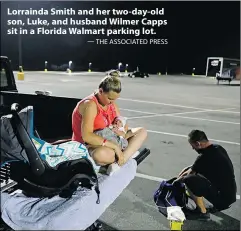  ?? — THE ASSOCIATED PRESS ?? Lorrainda Smith and her two-day-old son, Luke, and husband Wilmer Capps sit in a Florida Walmart parking lot.
