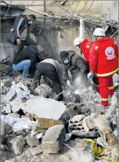  ?? Mohammad Zaatari Associated Press ?? WORKERS search for victims after a paramedics center was struck Wednesday in Hebbariye, Lebanon.