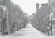  ?? STEVE APPS/ WISCONSIN STATE JOURNAL VIA AP ?? In a familiar scene across the USA during the pandemic lockdowns of 2020, State Street in Madison, Wis., was mostly empty last spring. As people went, so did their dollars.