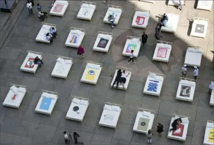  ?? PAUL CHIASSON, THE CANADIAN PRESS ?? People lie on beds as a representa­tion of the famous Lennon-Ono 1969 bed-in on the Internatio­nal Day of Peace on Thursday in Montreal.