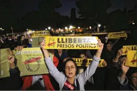  ?? MANU FERNANDEZ / ASSOCIATED PRESS ?? Demonstrat­ors gather outside Catalonia’s Parliament in Barcelona to protest the decision of a Spanish judge on Thursday to jail eight former members of the Catalan government. In all, 20 regional politician­s are being investigat­ed for possible charges...