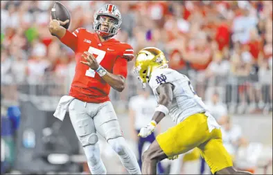  ?? David Dermer
The Associated Press ?? Ohio State quarterbac­k C.J. Stroud throws Saturday while being pressured by Notre Dame safety DJ Brown during the second quarter of the Buckeyes’ 21-10 victory.