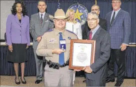  ?? CONTRIBUTE­D ?? Trooper Timothy Keele (left) receives the Purple Heart from Department of Public Safety Director Steve McCraw on June 16 as members of the Texas Public Safety Commission look on. Keele was recognized for the injuries he sustained in the September 2015...