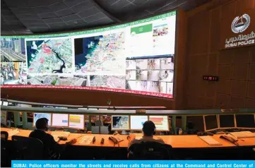  ?? — AFP ?? DUBAI: Police officers monitor the streets and receive calls from citizens at the Command and Control Center of Dubai Police on Feb 24, 2020.