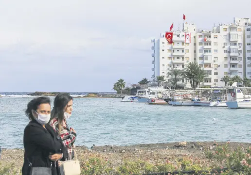  ??  ?? Women walk in the port city of Famagusta near the town of Varosha, in Famagusta, Cyprus, Nov. 15, 2020.