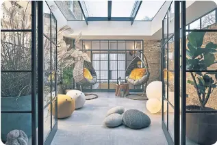  ?? ?? The glass doors in this indoor courtyard create a semi-private space that still feels connected to the rest of the home.