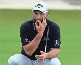  ?? FERNANDO LLANO/AP ?? Jon Rahm lines up a putt on the 18th green during a practice round Wednesday at the Hero World Challenge.