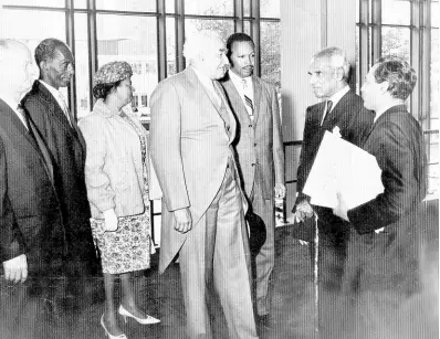  ?? THE GLEANER ARCHIVES ?? Sir Alexander Bustamante (centre) is greeted by Krishna Menon (second right), head of the Indian delegation to the United Nations (UN), and his aide on the occasion of the hoisting of Jamaica’s flag at the UN. Others from left are John P. Gyles, minister of agricultur­e and lands; Robert Lightbourn­e, minister of Trade and industry; Lady Bustamante; Senator Hugh Shearer, leader of Government Business in the Jamaican Senate; Mr Menon and his aide