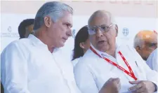  ?? REUTERS ?? Ricardo Cabrisas, chief debt negotiator, right, with Cuba’s President Miguel Diaz-Canel, says all payments to 14 nations will be made.
