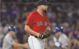  ?? STAFF PHOTO BY CHRISTOPHE­R EVANS ?? LEFT THE YARD: Brian Johnson watches the replay after giving up a solo home run to the Mets' Jeff McNeil during the fourth inning of the Sox' 8-0 loss last night.