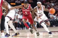  ?? (Meredith Seaver/College Station Eagle via AP) ?? Texas A&M guard Tyrece Radford (23) tries to dribble around Arkansas guard Davonte Davis (4) Feb. 15 during an NCAA college basketball game in College Station, Texas.