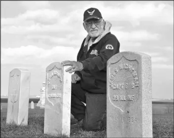  ?? JOY BUTLER/PONTIAC DAILY LEADER VIA AP ?? Harold Schook, an Air Force veteran who every year plants small American flags near area veterans’ graves, examines five new Civil War-era gravestone­s belonging to soldiers at the Odell Township Cemetery in Odell, Ill.