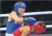  ??  ?? India's Mary Kom (in blue) fights Sri Lanka's Anusha Dilrukshi Koddithuwa­kku (in red) during their women's 45-48kg semi-final boxing match at the Oxenford Studios in Gold Coast on Wednesday.